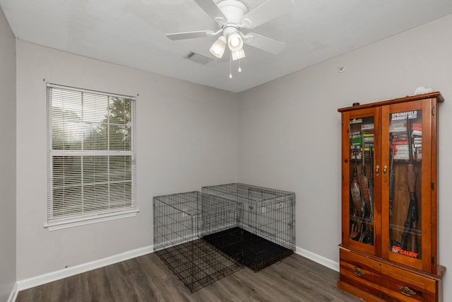 empty room with ceiling fan and dark hardwood / wood-style flooring