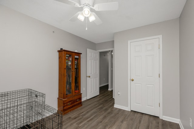 interior space featuring dark wood-type flooring and ceiling fan