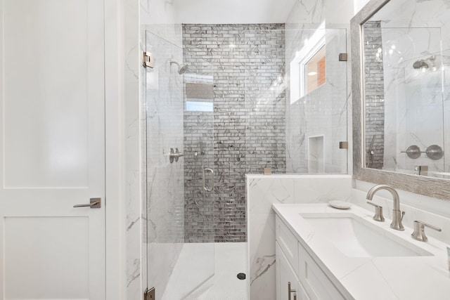 bathroom with walk in shower and vanity