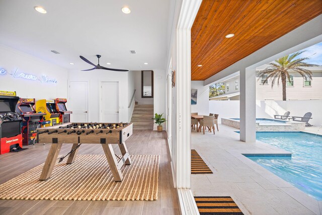 recreation room featuring a swimming pool, ceiling fan, wood ceiling, and light hardwood / wood-style flooring