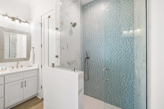 bathroom featuring an enclosed shower, vanity, and hardwood / wood-style flooring