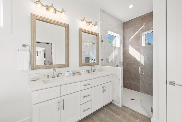 bathroom featuring an enclosed shower and vanity