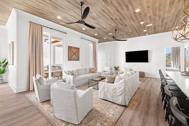 living room with ceiling fan with notable chandelier, wooden ceiling, and light hardwood / wood-style flooring