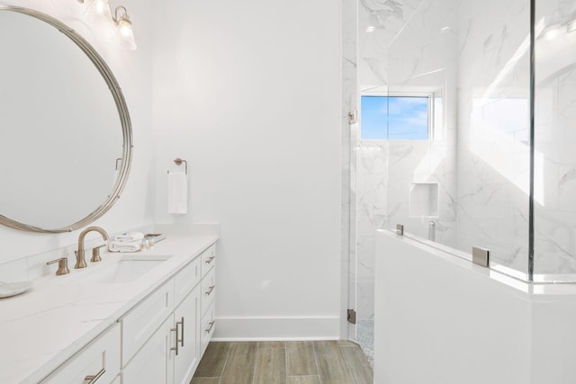 bathroom with hardwood / wood-style floors, a shower with door, and vanity