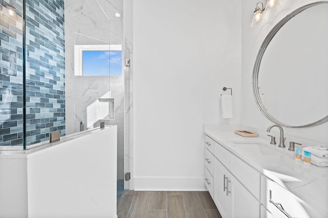 bathroom with a shower with door and vanity