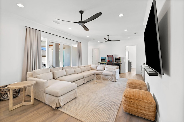 living room featuring ceiling fan and light hardwood / wood-style flooring