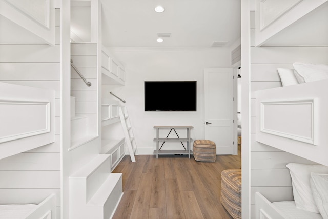 unfurnished living room featuring ornamental molding and wood-type flooring