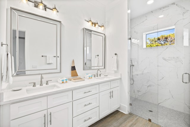 bathroom featuring walk in shower, wood-type flooring, and vanity