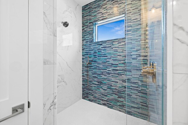 bathroom with a tile shower