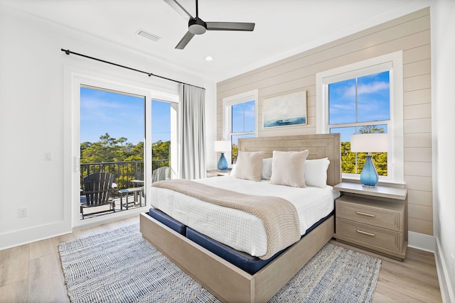 bedroom featuring access to outside, multiple windows, ceiling fan, and light hardwood / wood-style flooring