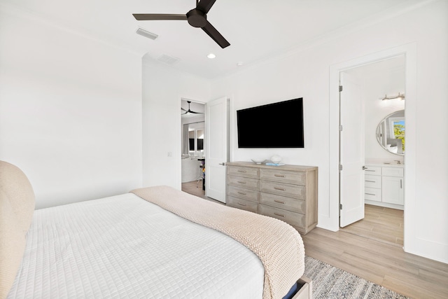 bedroom with crown molding, sink, light hardwood / wood-style floors, ceiling fan, and ensuite bathroom