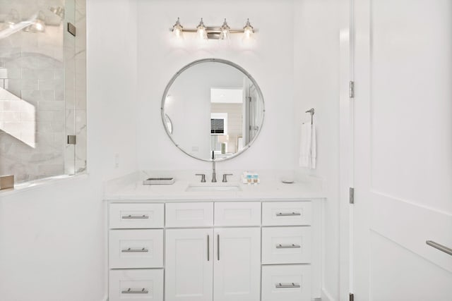 bathroom featuring walk in shower and vanity