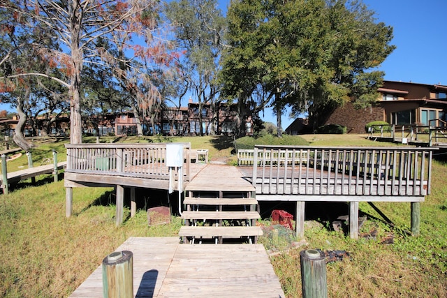 dock area featuring a wooden deck and a yard