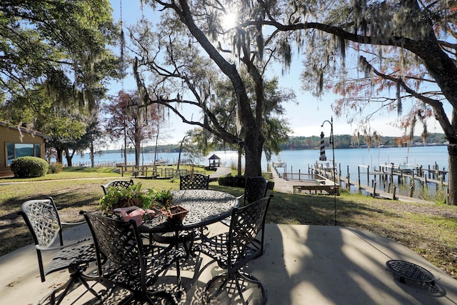 view of patio with a boat dock and a water view