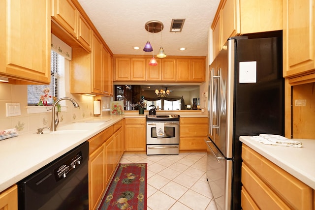 kitchen with sink, hanging light fixtures, light tile patterned floors, stainless steel appliances, and a textured ceiling