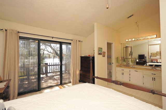 bedroom featuring lofted ceiling and access to exterior