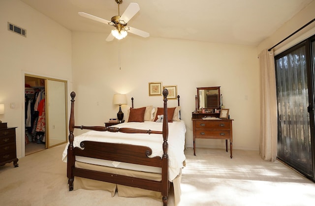 carpeted bedroom with ceiling fan, vaulted ceiling, and a closet