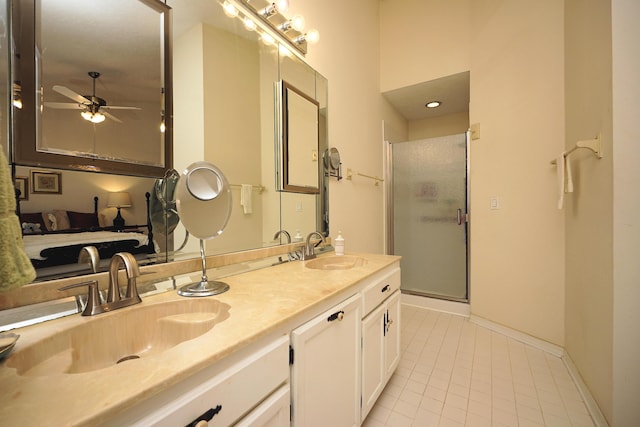 bathroom featuring ceiling fan, vanity, a shower with shower door, and tile patterned flooring