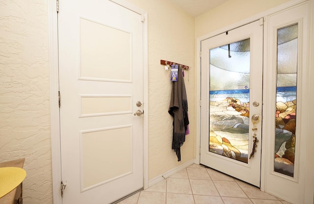 doorway to outside featuring light tile patterned floors