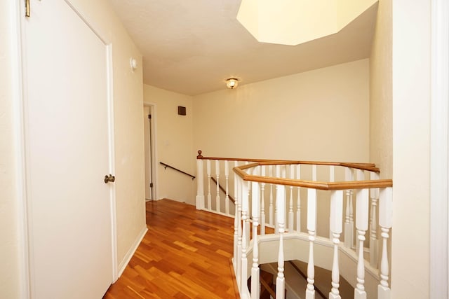 corridor with hardwood / wood-style flooring