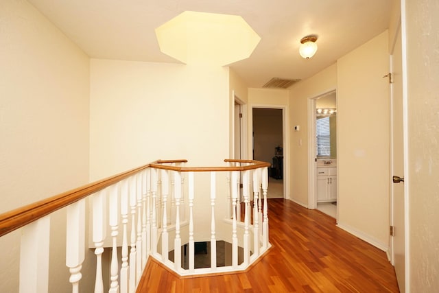 hallway with hardwood / wood-style floors