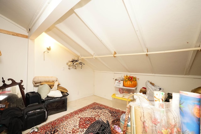 interior space featuring vaulted ceiling and concrete flooring