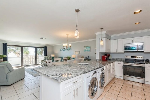 kitchen featuring kitchen peninsula, hanging light fixtures, independent washer and dryer, appliances with stainless steel finishes, and white cabinetry