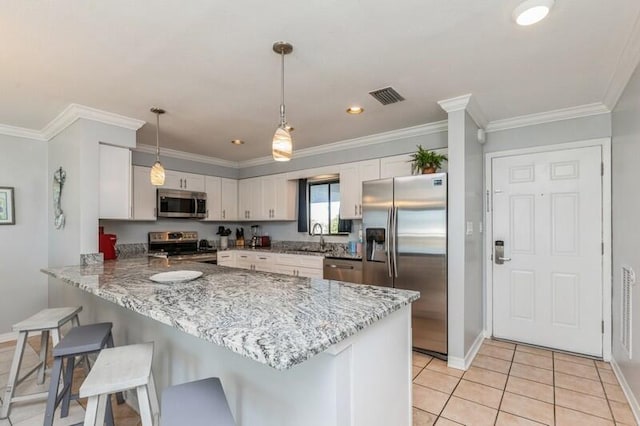 kitchen with white cabinetry, kitchen peninsula, decorative light fixtures, light tile patterned floors, and appliances with stainless steel finishes