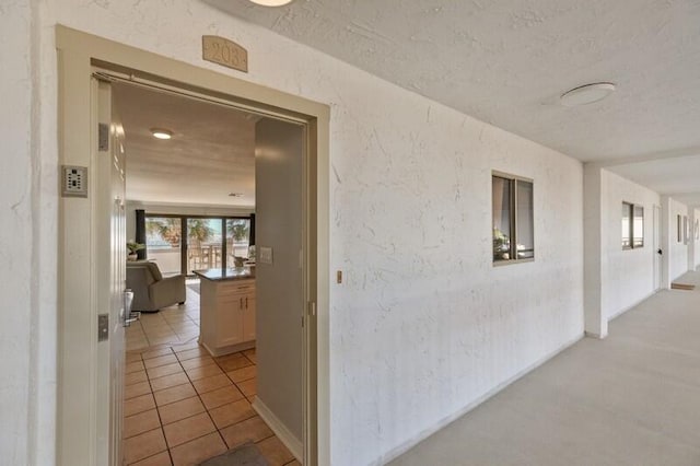 hallway featuring light tile patterned floors