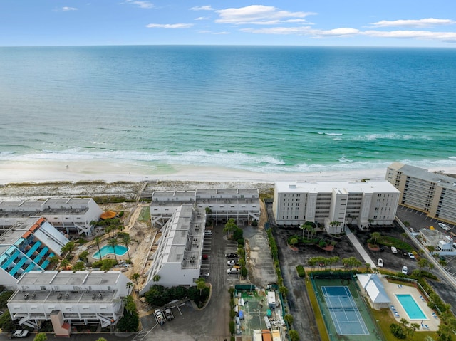 birds eye view of property with a water view and a view of the beach