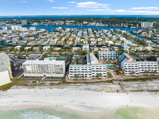 birds eye view of property with a water view and a view of the beach