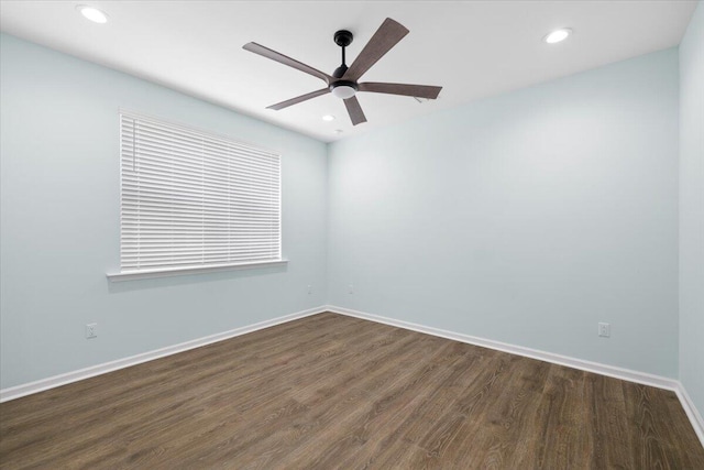 unfurnished room featuring dark wood-type flooring and ceiling fan