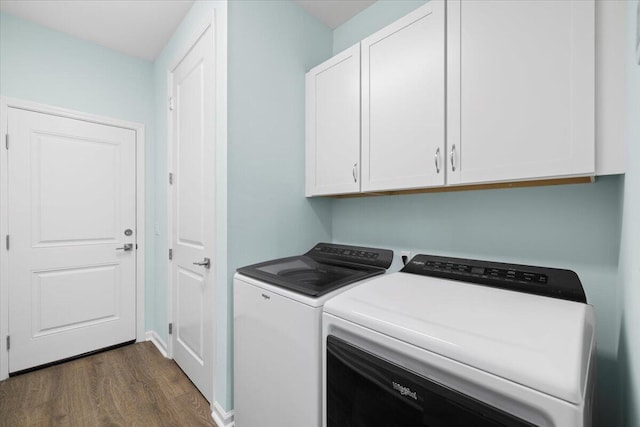 laundry room featuring cabinets, dark hardwood / wood-style floors, and separate washer and dryer