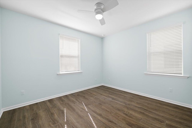 spare room featuring dark wood-type flooring and ceiling fan