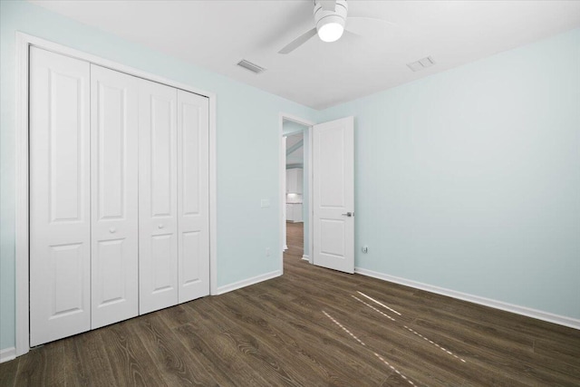 unfurnished bedroom featuring dark hardwood / wood-style flooring, a closet, and ceiling fan