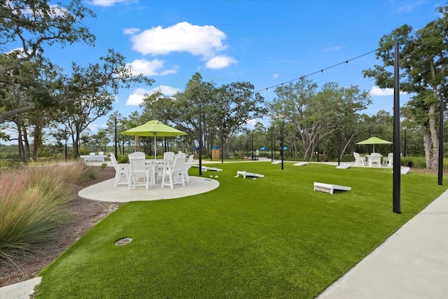 view of property's community featuring a patio area and a yard