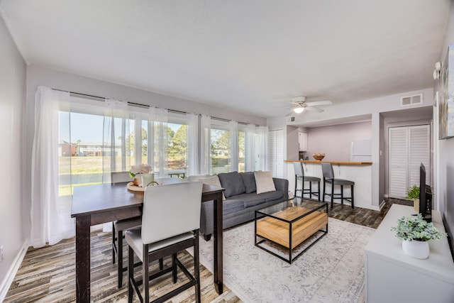 living room featuring hardwood / wood-style flooring and ceiling fan