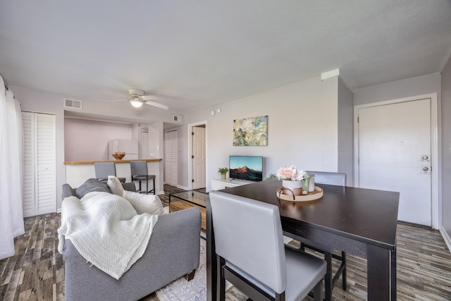 living room featuring ceiling fan and hardwood / wood-style floors