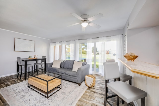 living room featuring ceiling fan and light hardwood / wood-style flooring