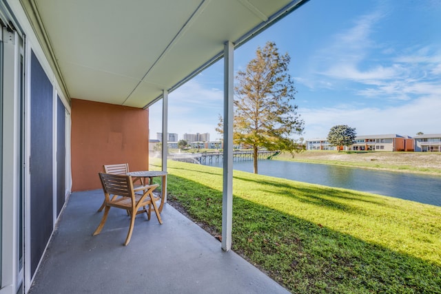 sunroom / solarium with a water view