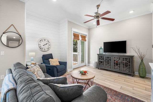 living room featuring hardwood / wood-style flooring, ceiling fan, and crown molding