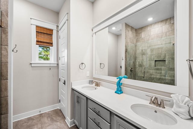 bathroom featuring tile patterned flooring, vanity, and walk in shower