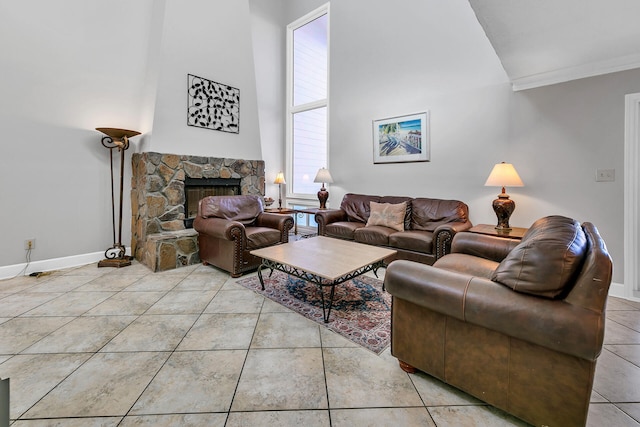 900 Gulf Shore Dr Unit 03, Destin, FL 32541 - living area with crown molding, high vaulted ceiling, light tile patterned floors, baseboards, and a stone fireplace
