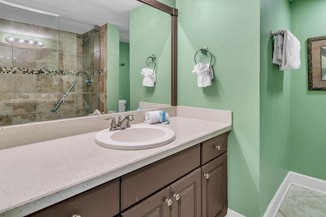 900 Gulf Shore Dr Unit 03, Destin, FL 32541 - full bath featuring vanity, tiled shower, toilet, baseboards, and marble look tile flooring