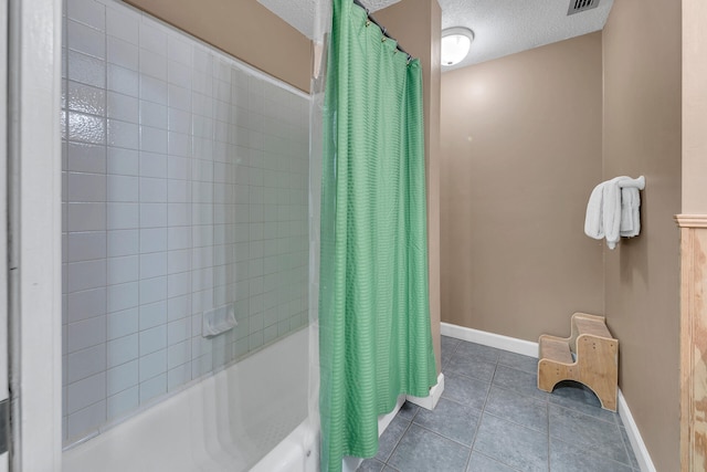 900 Gulf Shore Dr Unit 03, Destin, FL 32541 - full bath featuring shower / tub combo with curtain, a textured ceiling, tile patterned floors, and baseboards