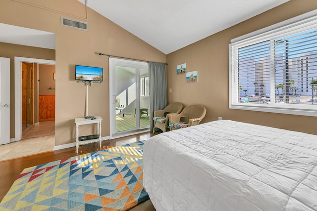 900 Gulf Shore Dr Unit 03, Destin, FL 32541 - bedroom with multiple windows, access to outside, wood finished floors, lofted ceiling, and baseboards