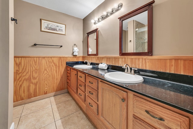 900 Gulf Shore Dr Unit 03, Destin, FL 32541 - bathroom featuring a wainscoted wall, double vanity, tile patterned floors, and wood walls