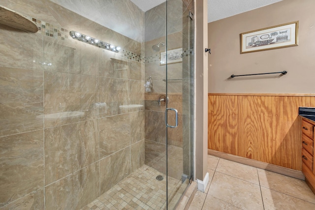 900 Gulf Shore Dr Unit 03, Destin, FL 32541 - full bath with a stall shower, a wainscoted wall, tile patterned floors, and vanity