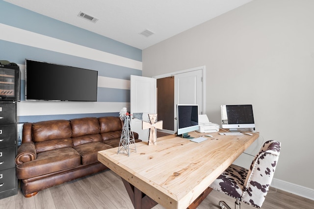 home office with wood-type flooring