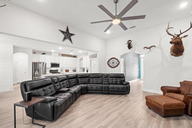 living room featuring ceiling fan and light hardwood / wood-style flooring